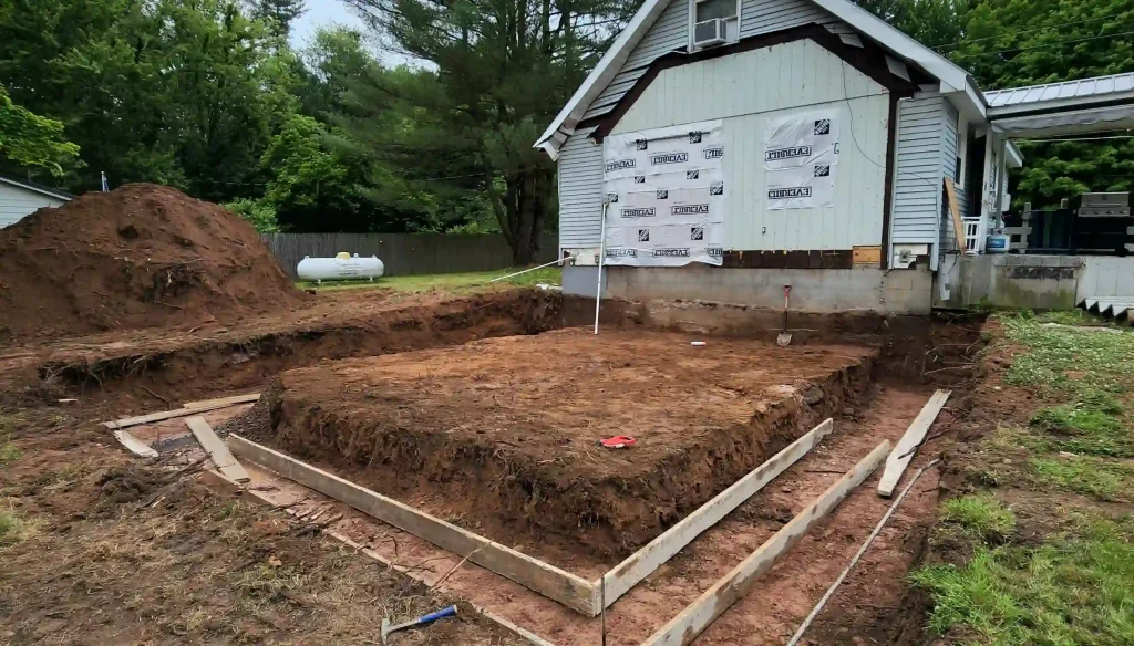 Excavation work in Manlius NY for backyard patio and retaining wall installation