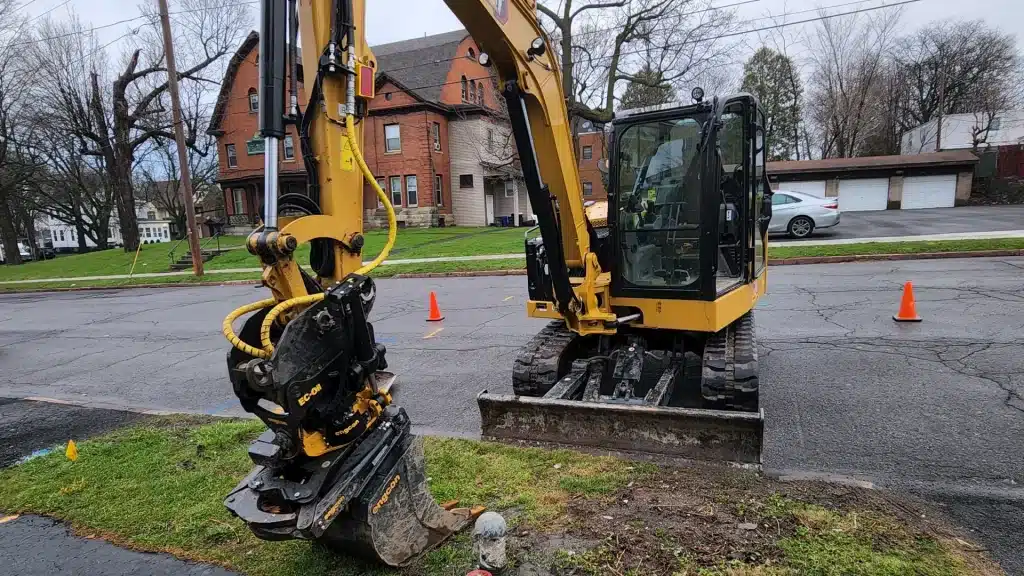 GPS-guided excavator grading a residential yard in Fayetteville NY
